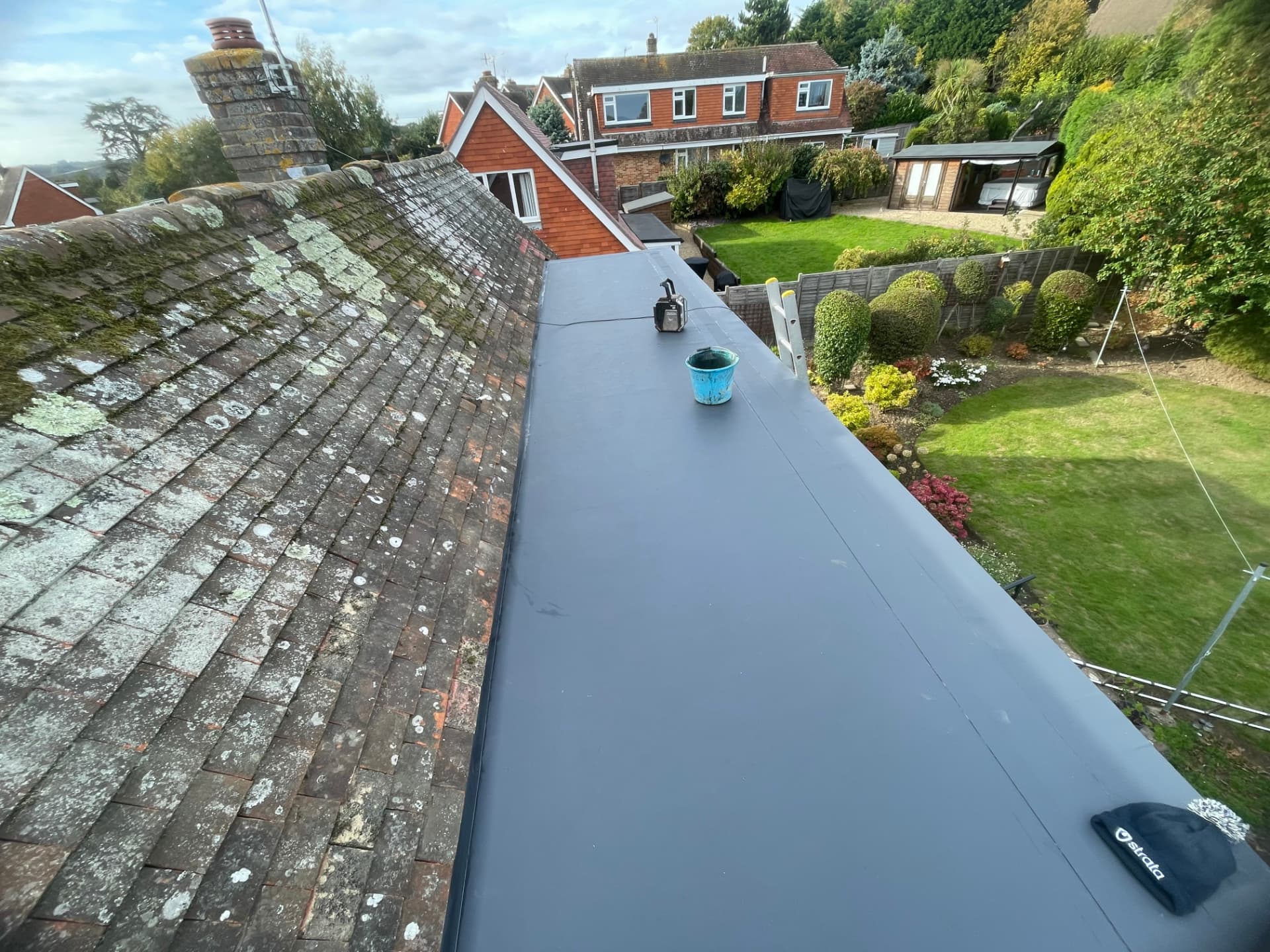 Flat roof renewal alongside an existing tiled roof