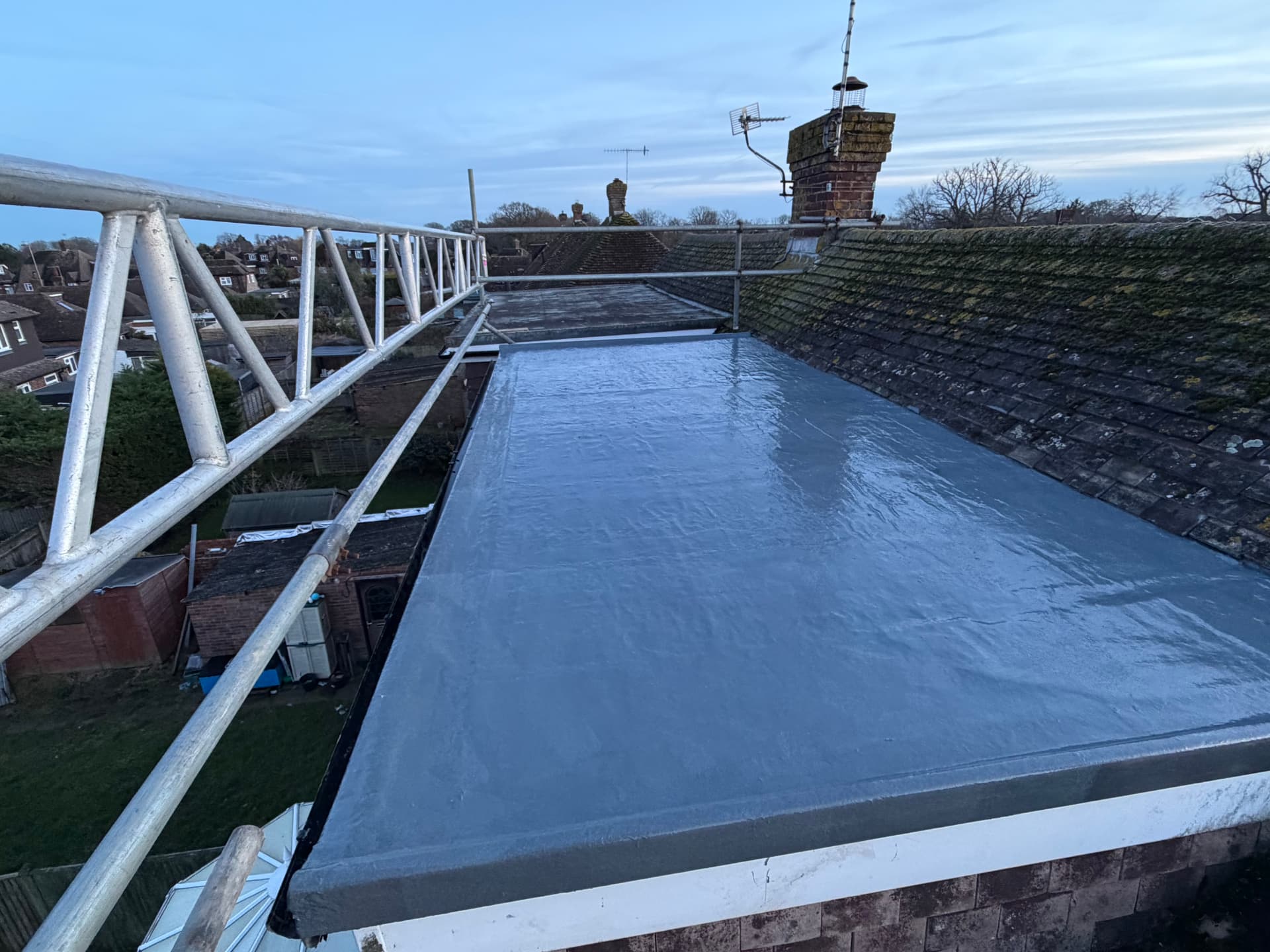 Freshly coated flat roof with scaffolding in place